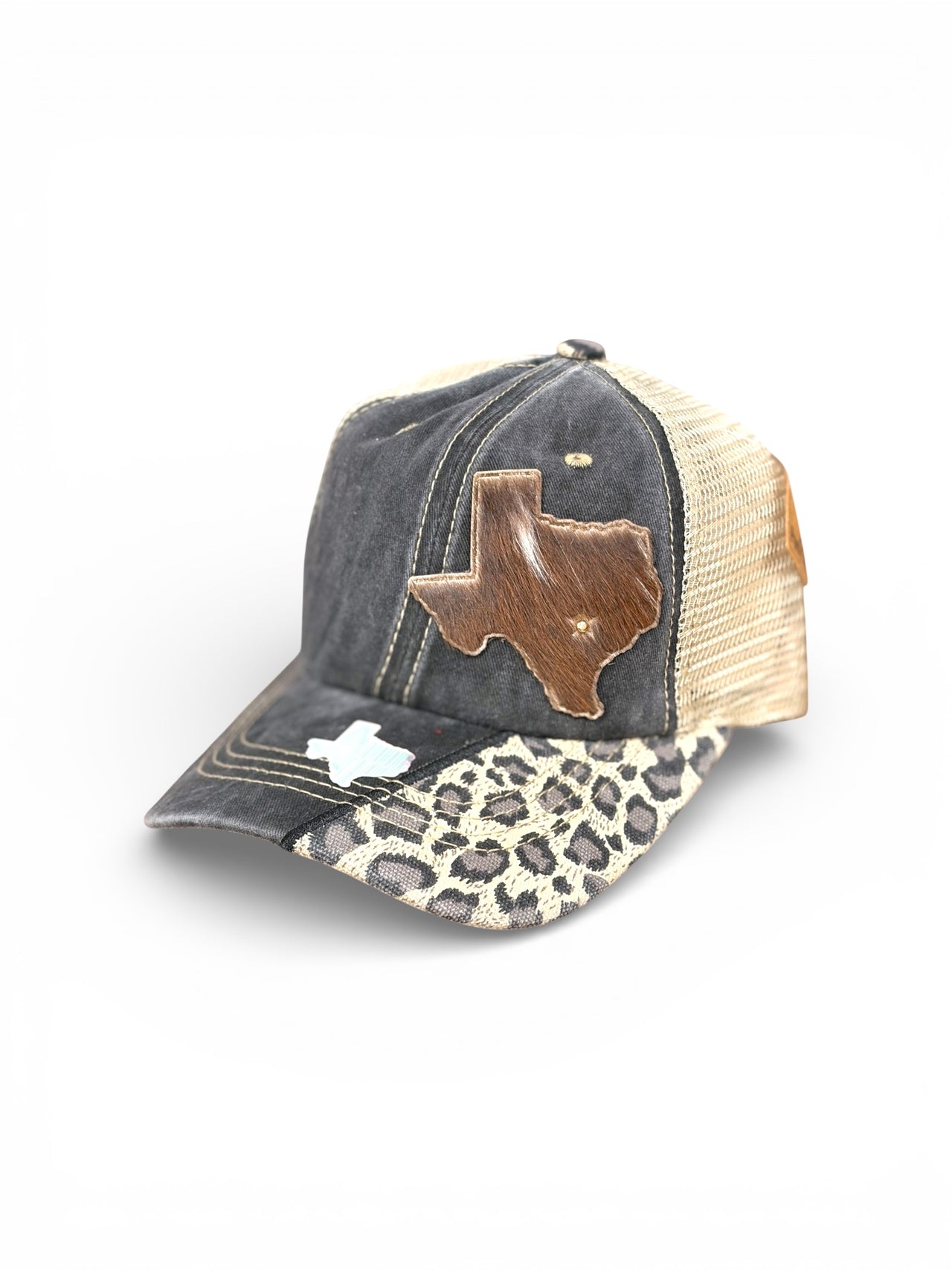 Distressed charcoal trucker hat with genuine cowhide Texas patch, leopard print bill, cream mesh back, and holographic Texas accent.