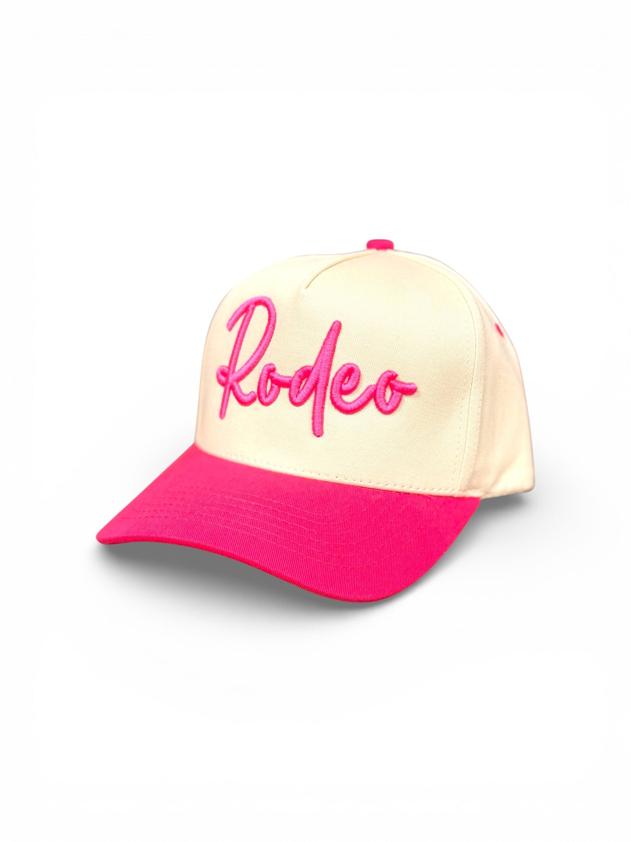 Cream hat with raised hot-pink embroidered Rodeo script and matching pink bill